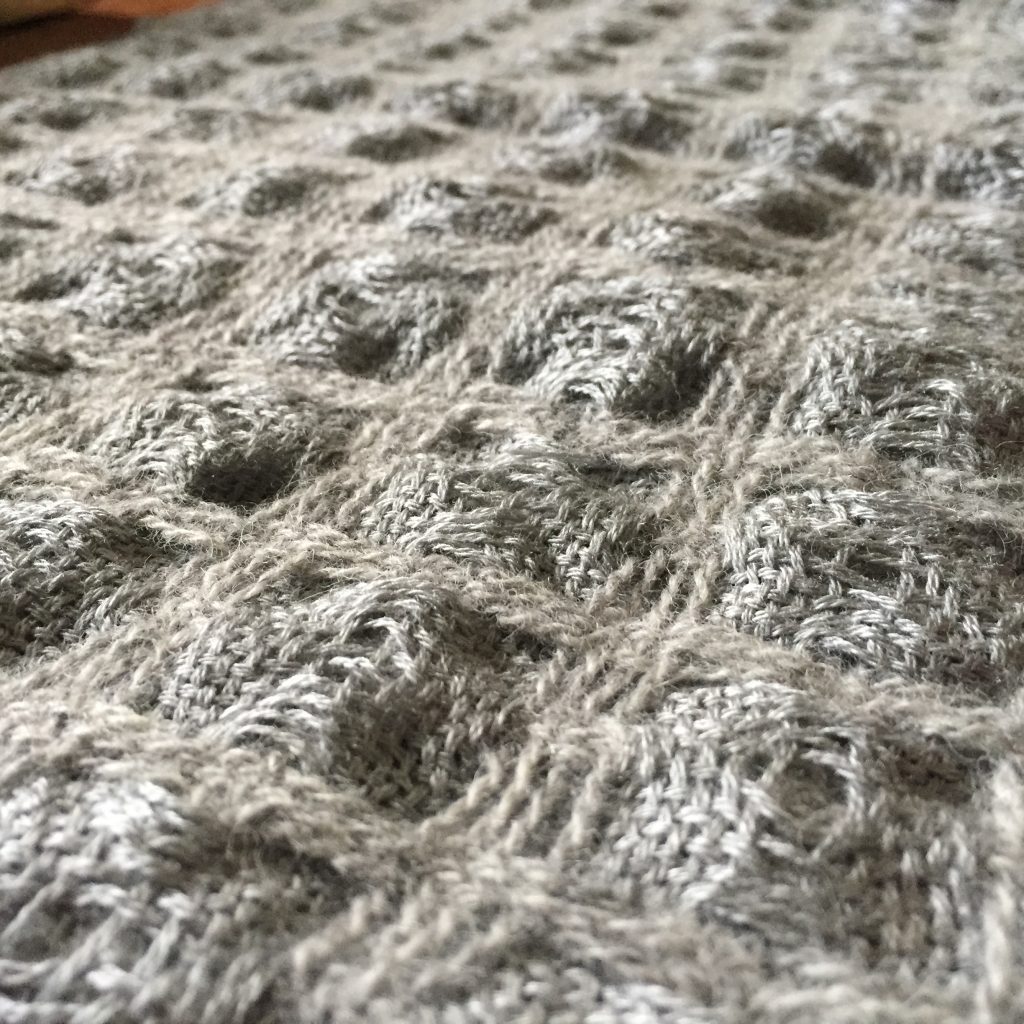 Detail of deflected doubleweave scarf with differential shrinkage to create egg-carton-like texture